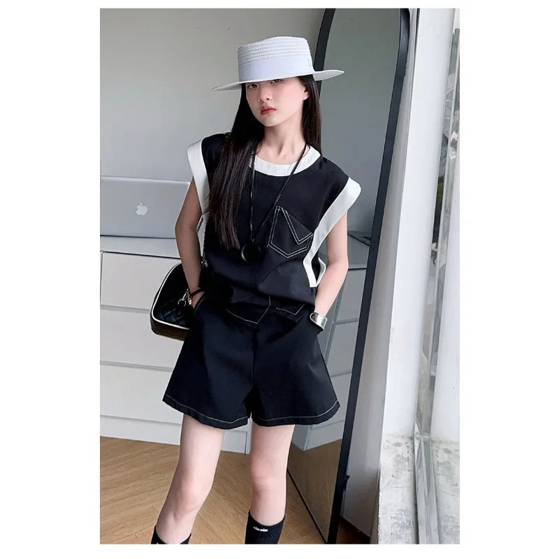 Black and White Spliced Vest and Shorts Two-Piece Casual Sports Outfit Set worn by woman with white hat indoors