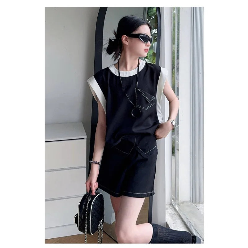Black and White Spliced Vest and Shorts Two-Piece Casual Sports Outfit Set worn by woman with sunglasses and black quilted handbag