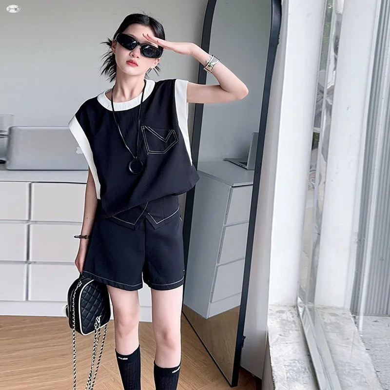 Black and White Spliced Vest and Shorts Two-Piece Casual Sports Outfit Set worn by model with sunglasses and handbag