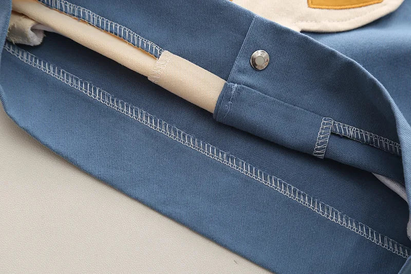 Close up of blue fabric and button detail on Boys Cartoon Excavator Jacket T-shirt and Pants Tracksuit Set for Autumn