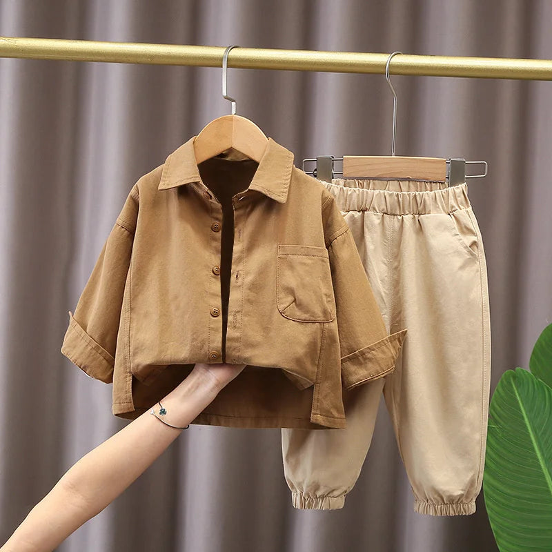 Boys' Casual Fashion Set Long Sleeve Shirt & Cargo Pants trendy daily wear in brown and beige hanging on a gold clothing rack
