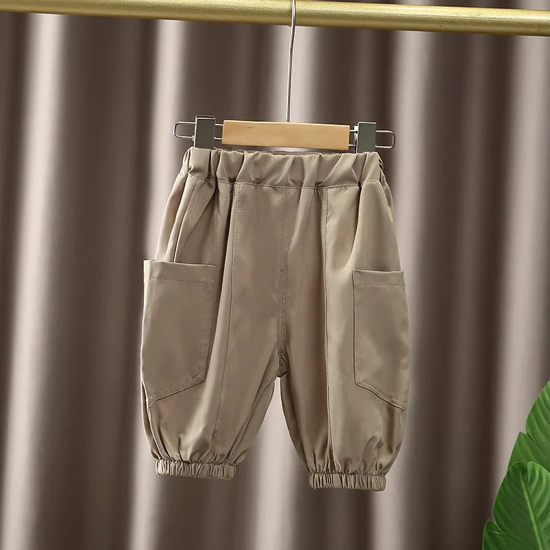 Boys Korean Fashion Stripe Short Sleeve Top and Pants Summer Kids Outfit Set beige pants with elastic waist and pockets hanging on wooden hanger