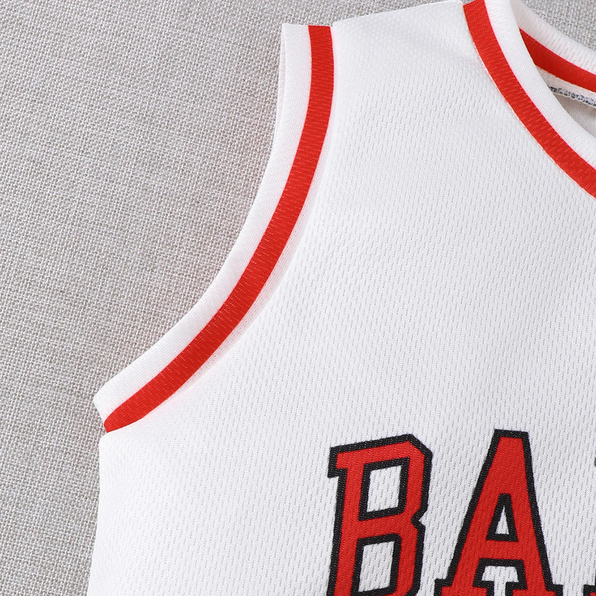 Close-up of white Boys Sports Style Set Round Neck Letter 23 Basketball Suit 2 Piece Summer Outfit with red trim