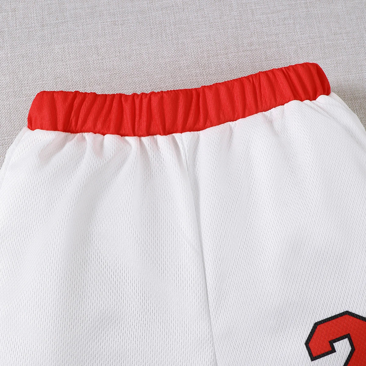Close-up of white shorts with red elastic waistband and number 23 detail in Boys Sports Style Set Round Neck Letter 23 Basketball Suit 2 Piece Summer Outfit