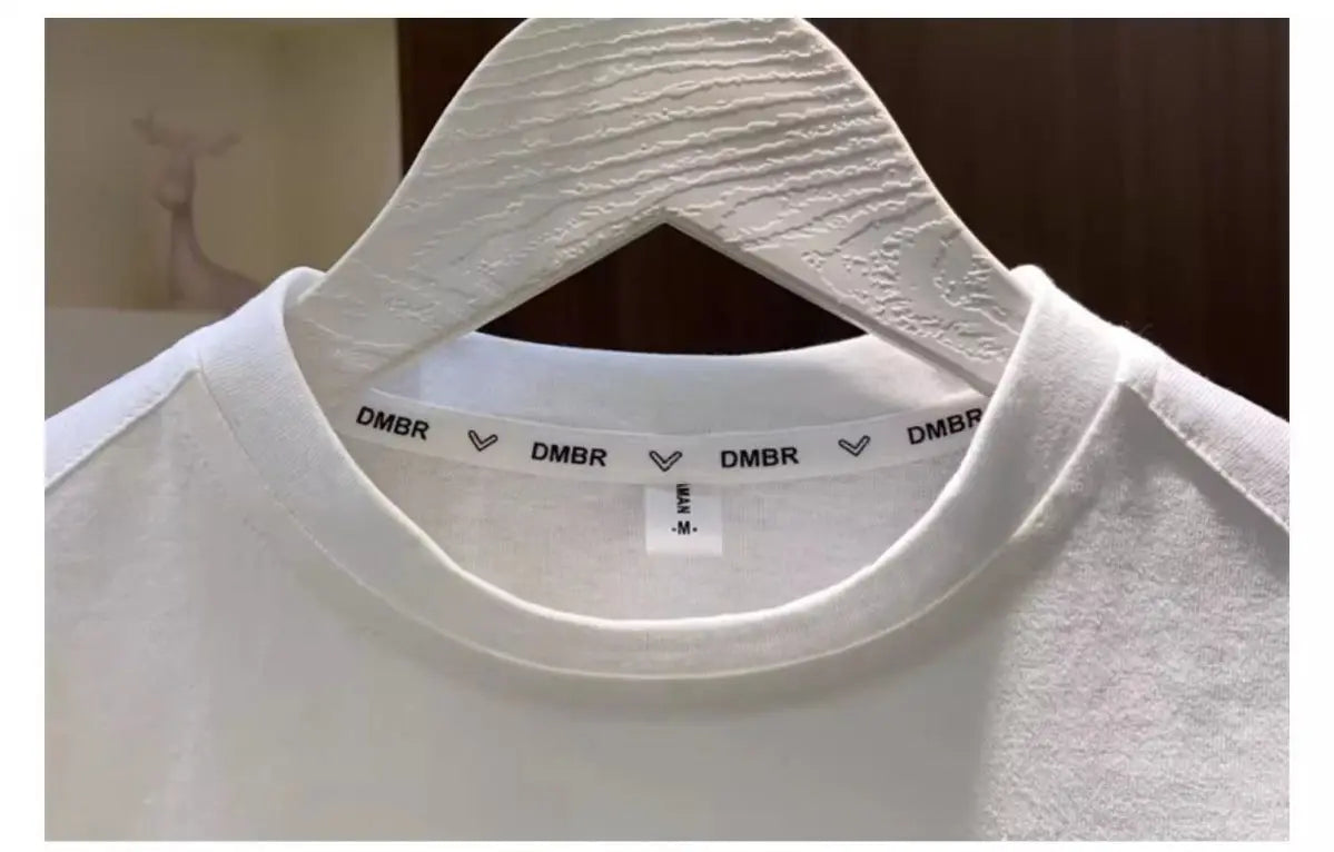 White Boys Summer Two Piece Set Korean Style T Shirt and Shorts Casual Outfit hanging on wooden hanger