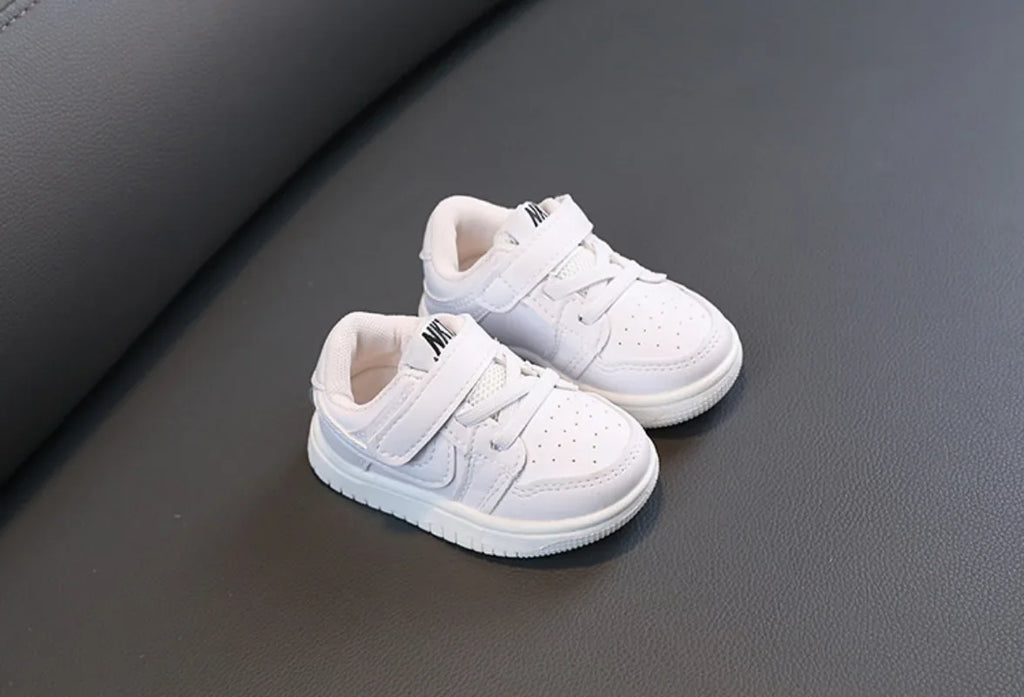 Children White Casual Sneakers Soft-Soled Running Shoes for Boys and Girls displayed on dark surface