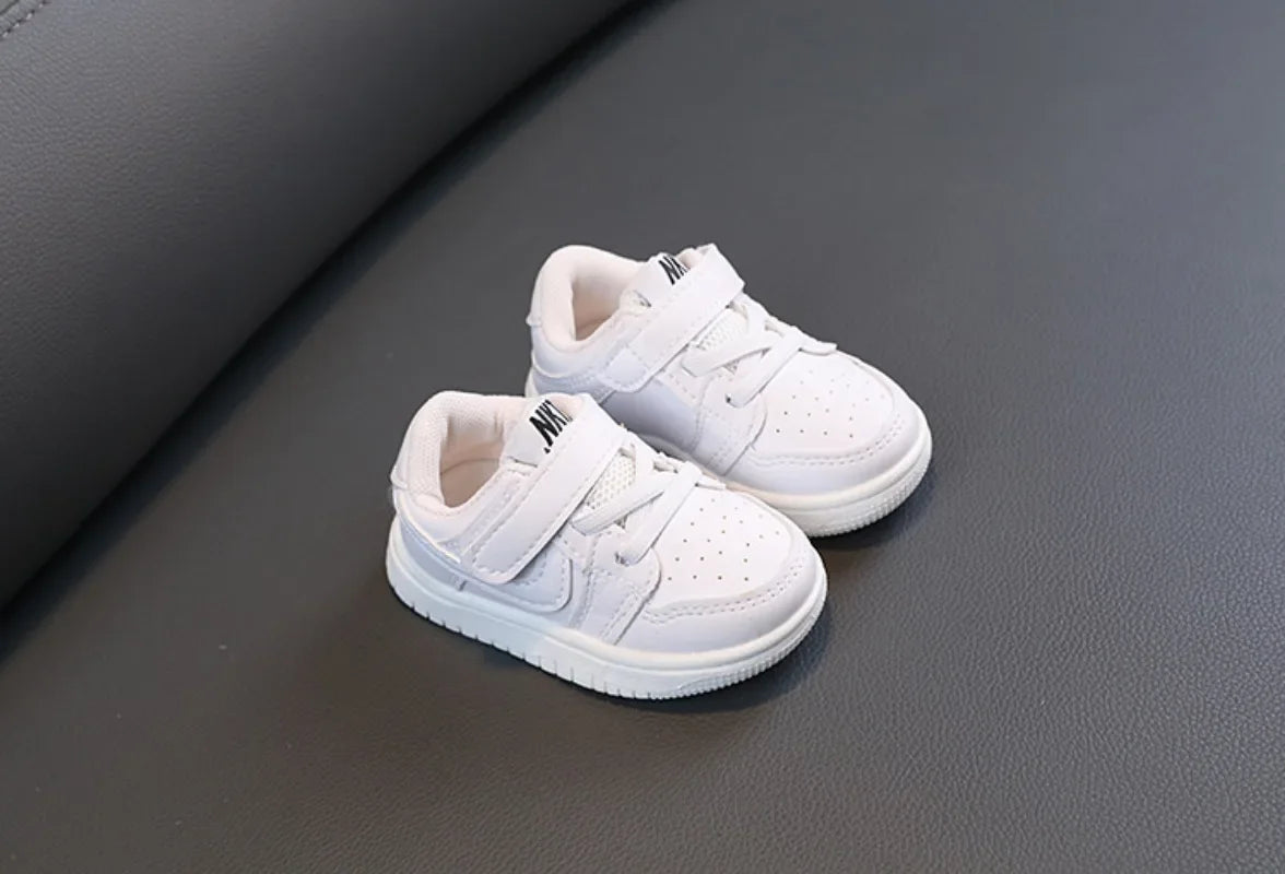 Children White Casual Sneakers Soft-Soled Running Shoes for Boys and Girls displayed on dark surface