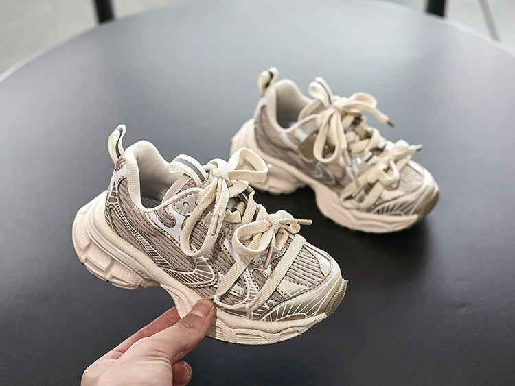 Kids Sneakers Breathable Soft Sole Running Shoes for Boys and Girls in beige with chunky design on black table