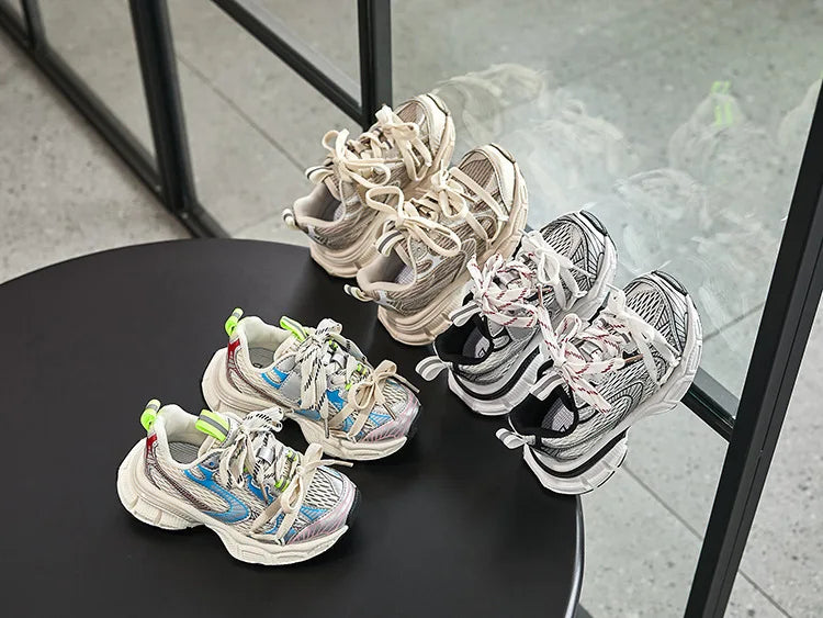 Kids Sneakers Breathable Soft Sole Running Shoes for Boys and Girls in various colors displayed on black table