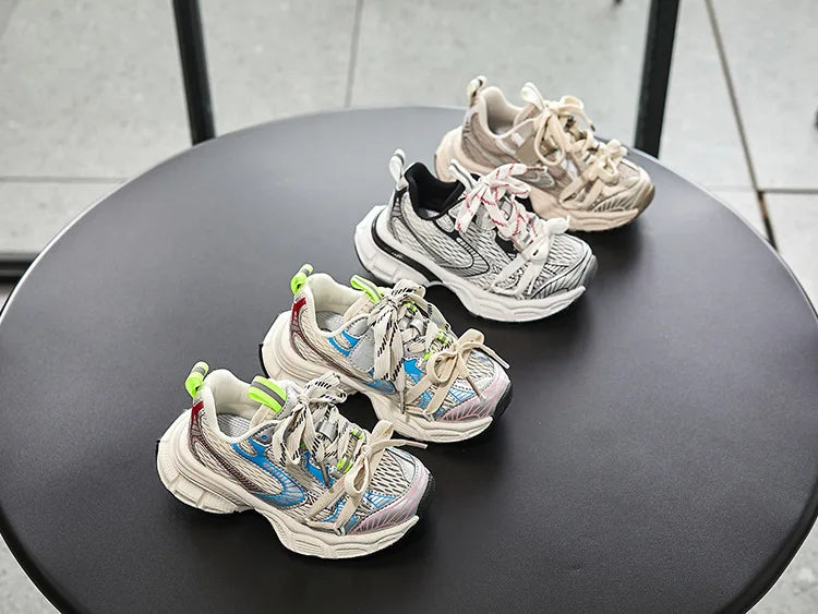 Kids Sneakers Breathable Soft Sole Running Shoes for Boys and Girls in multiple colors displayed on a round black table
