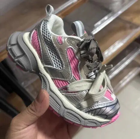 Kids Sneakers Breathable Soft Sole Running Shoes for Boys and Girls in pink and gray color held in hand