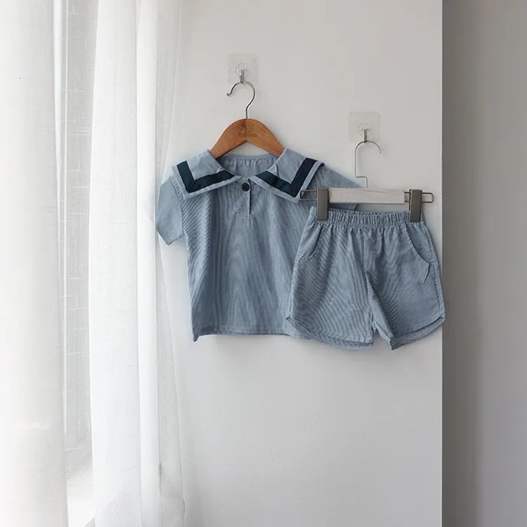 Children Clothing Sets Boys Girls Muslin Top Shorts 2pcs Cotton Baby Outfit in light blue hanging on wall