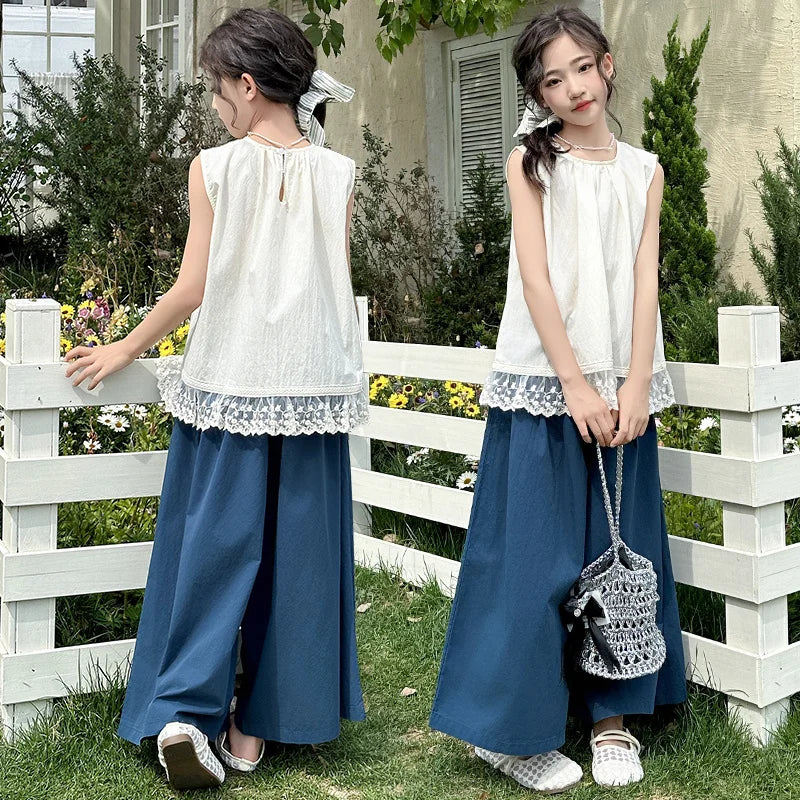 Children Clothing Sets Lace Sleeveless Top Wide-leg Denim Pants Girls Outfit worn by two girls standing outdoors near white fence