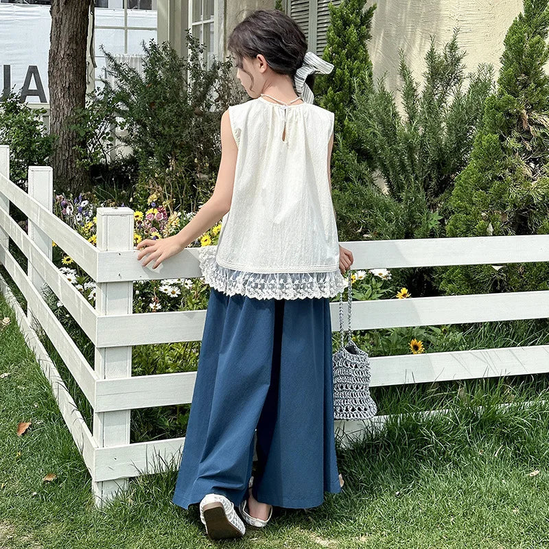 Children Clothing Sets Lace Sleeveless Top Wide-leg Denim Pants Girls Outfit shown on a girl standing near a white fence outside