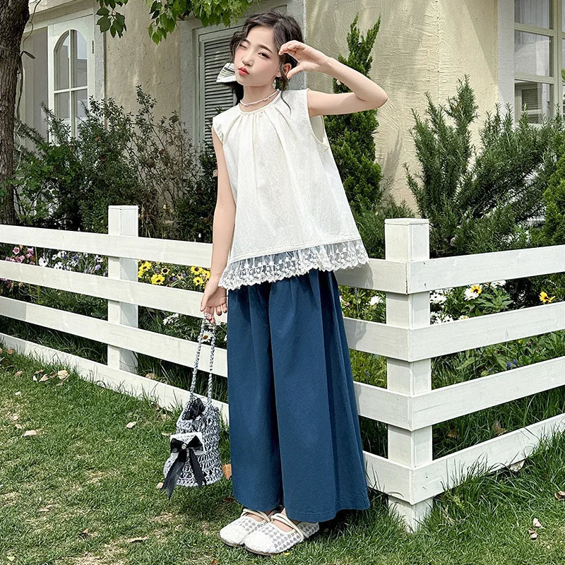 Children Clothing Sets Lace Sleeveless Top Wide-leg Denim Pants Girls Outfit worn by girl outdoors with white fence