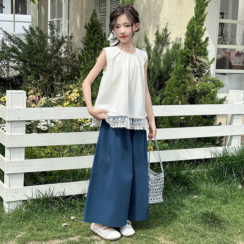 Children Clothing Sets Lace Sleeveless Top Wide-leg Denim Pants Girls Outfit worn by girl standing near white fence outdoors