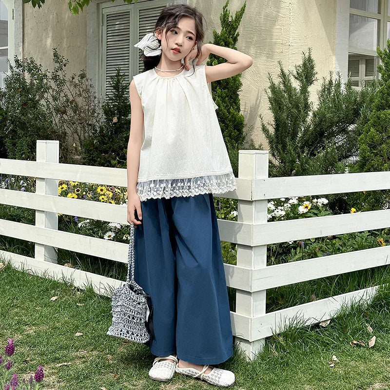 Children Clothing Sets Lace Sleeveless Top Wide-leg Denim Pants Girls Outfit modeled outdoors with white fence background
