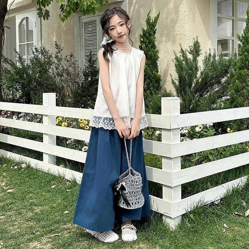Children Clothing Sets Lace Sleeveless Top Wide-leg Denim Pants Girls Outfit worn by a girl standing near white fence outdoors