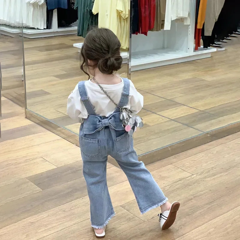 Children Clothing Sets Long Sleeve T Shirt Bow Suspenders Jeans Girls Baby Outfit shown on toddler from back in store