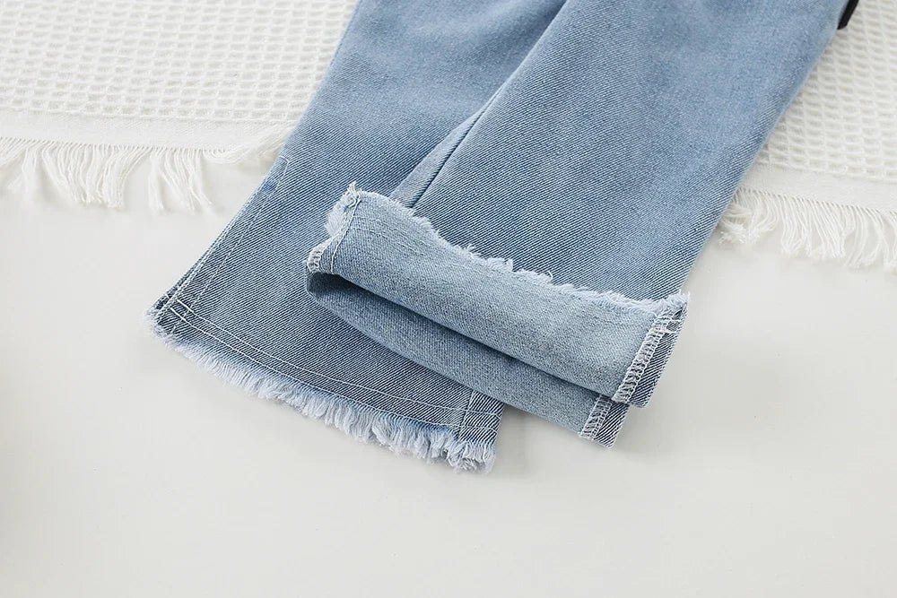 Folded blue jeans detail showing frayed hems for Children Clothing Sets Long Sleeve T Shirt Bow Suspenders Jeans Girls Baby Outfit