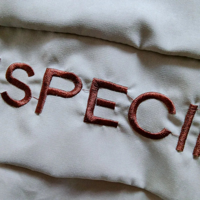 Close-up of embroidered text on a Korean style autumn spring long sleeve kids hooded coat by Yamza Tots Closet
