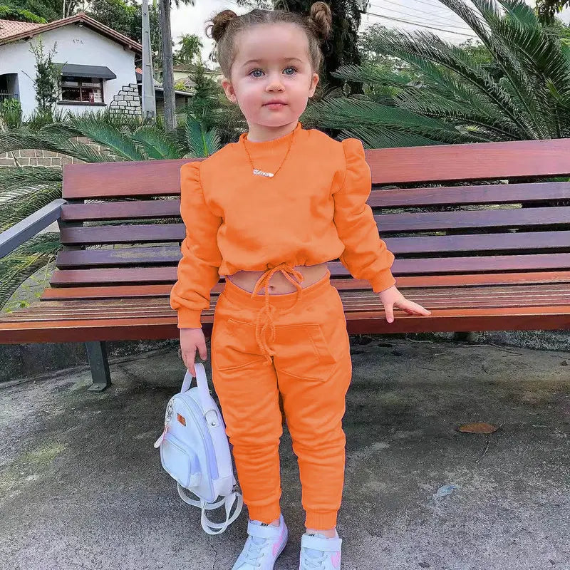Children Girls Clothes Set Autumn Long Sleeve Crop Tops and Casual Pants Outfit in bright orange worn by toddler with white shoes and backpack
