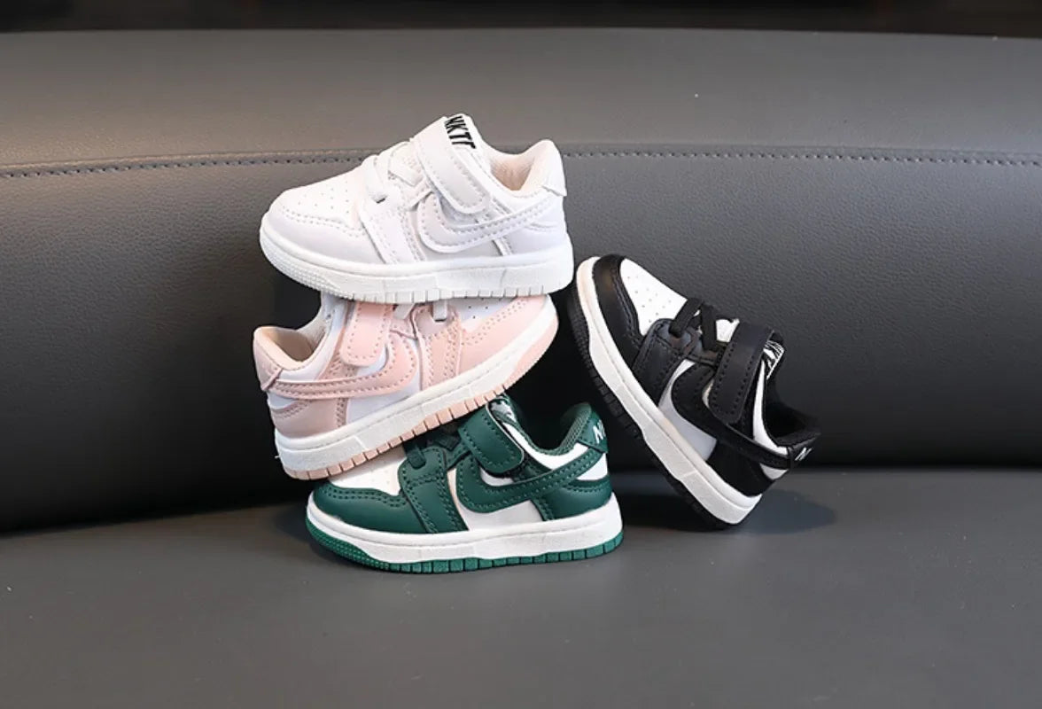 Children White Casual Sneakers Soft-Soled Running Shoes for Boys and Girls in white pink green and black colors stacked on black sofa