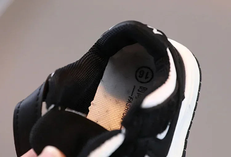 Black and white children's sneakers by Yamza Tots' Closet with cushioned interior for comfort
