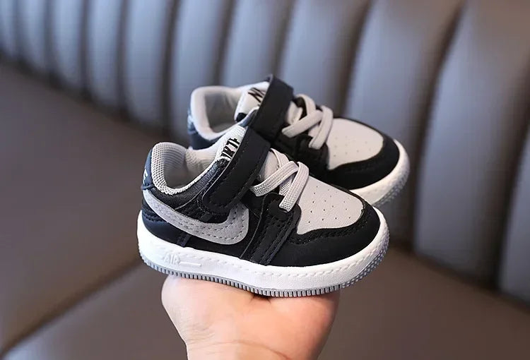 Yamza Tots' Closet black and white children's sneakers with velcro strap and lace detail
