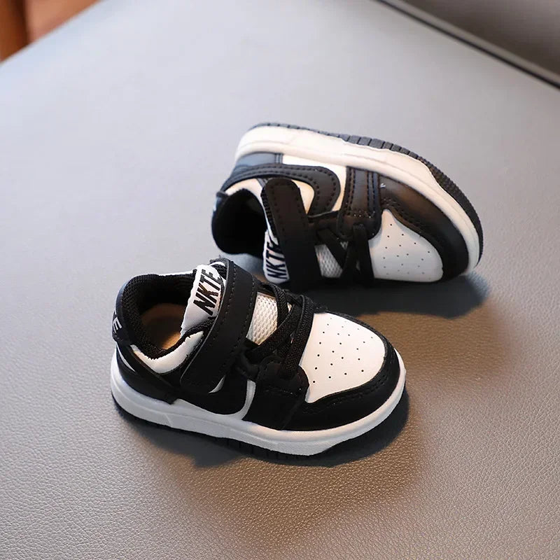 Black and white children's sneakers with velcro straps and breathable design by Yamza Tots' Closet