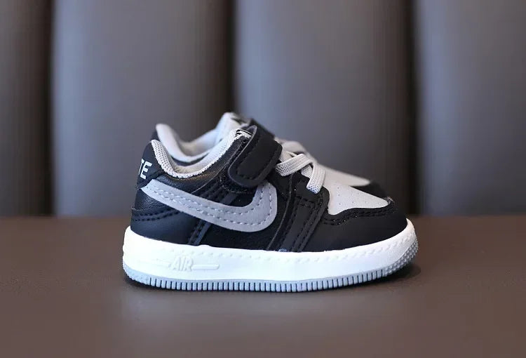 Black and white children's sneakers by Yamza Tots' Closet with velcro strap and cushioned sole