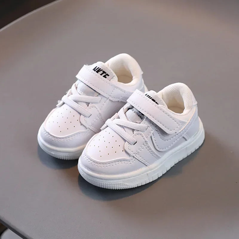 White children's sneakers with Velcro strap and perforated design from Yamza Tots' Closet