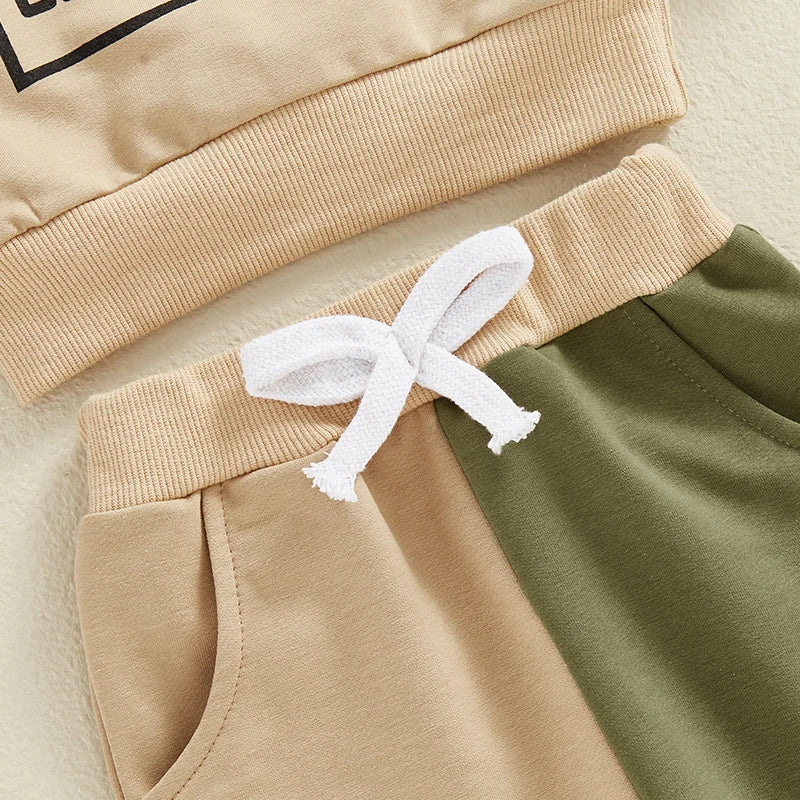 Close-up of boys outfits letter print with beige and green color block pants and elastic waistband