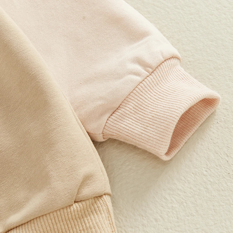Close-up of beige and light pink sleeves showing soft fabric and ribbed cuffs from Boys Outfits Letter Print by Yamza Tots' Closet