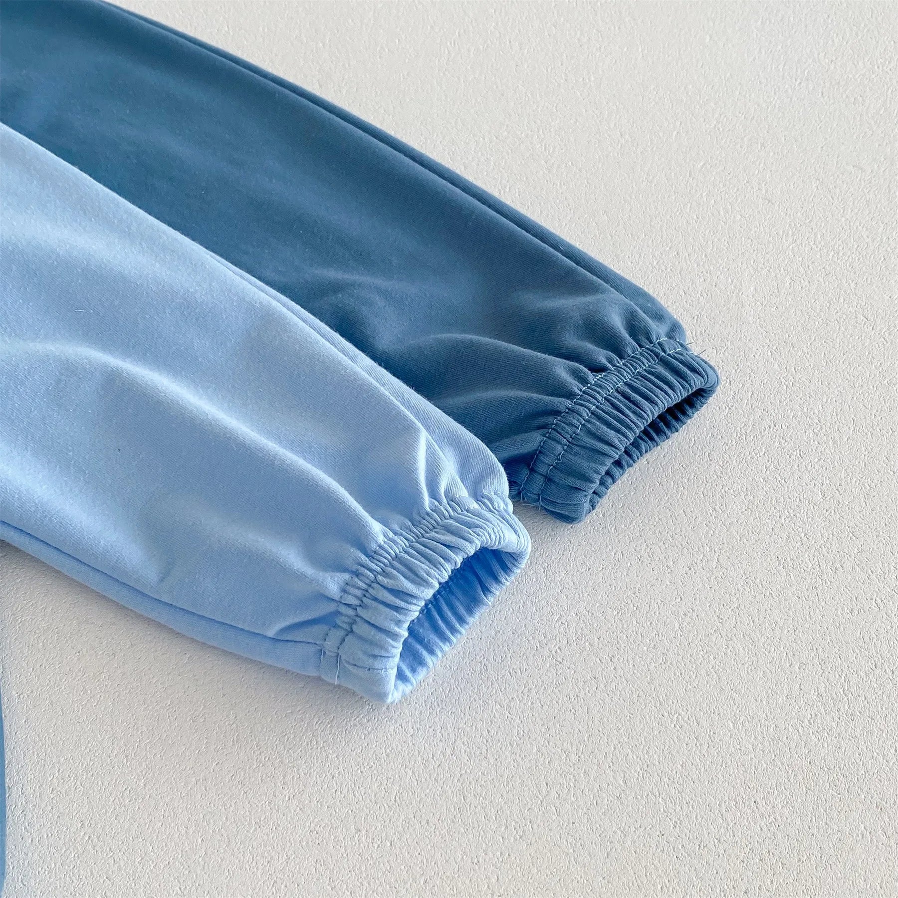 Close-up of light blue and dark blue elastic cuffs on Disney Cartoon Tracksuit by Yamza Tots' Closet