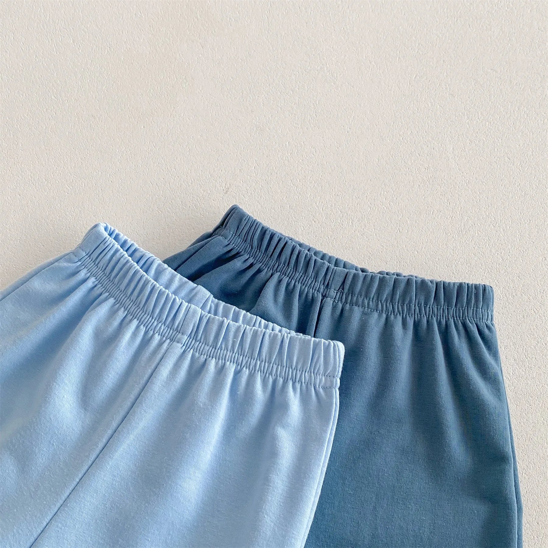Close-up of blue and navy elastic waistbands on Disney Cartoon Tracksuit pants from Yamza Tots' Closet