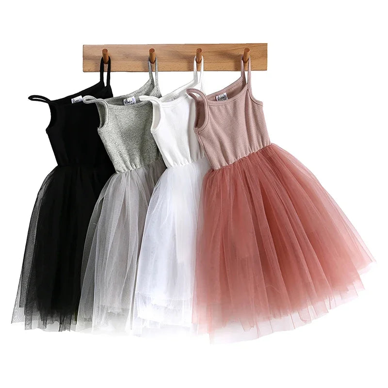Cute Girls Casual Solid Color Sleeveless Suspenders Dress Summer Kids Outfit in black gray white and pink colors hanging on wooden rack
