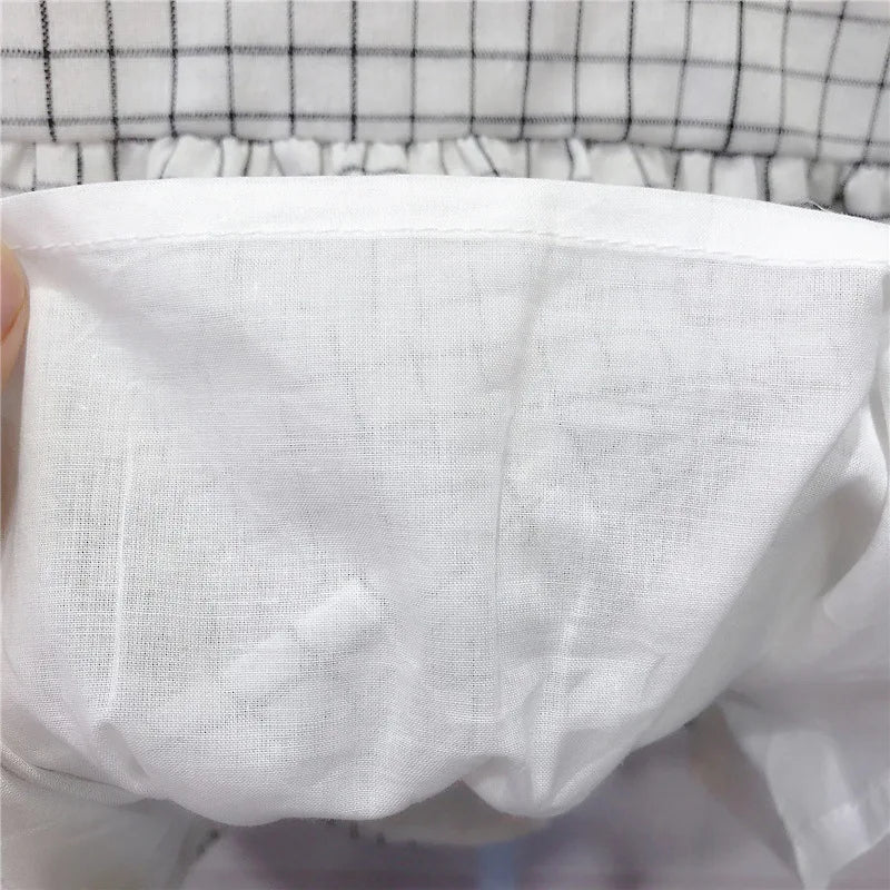 Close-up of soft white fabric lining with checkered design from Korean Fashion Matching Sister Brother Outfits Baby Kids Autumn Dress & Suit Set