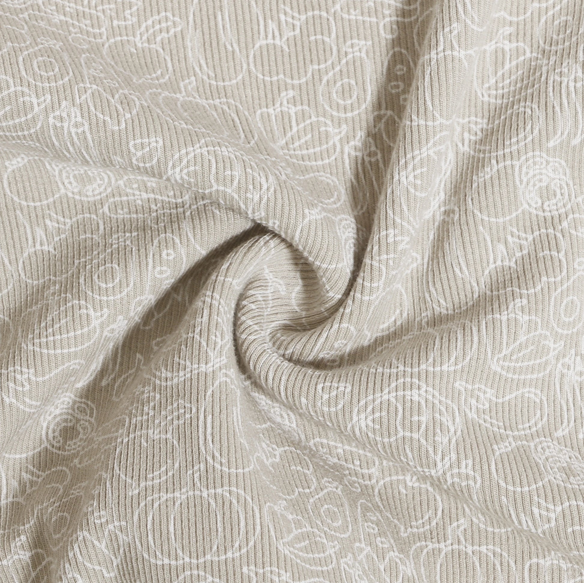 Close-up of beige fabric with white ribbed texture and cartoonish print from Family Ribbed Print Sets for Summer and Spring