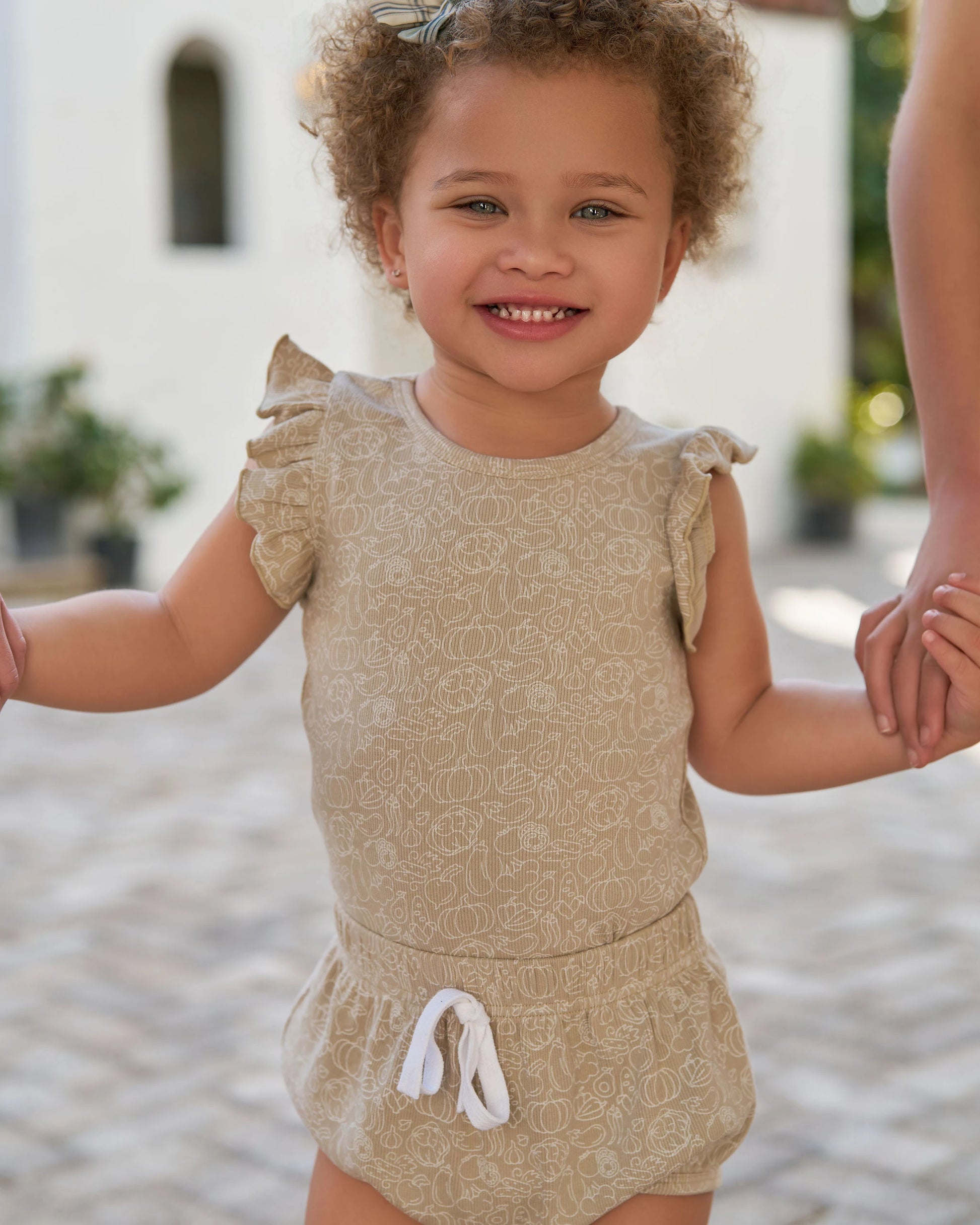 Toddler girl wearing beige Family Ribbed Print Sets for Summer and Spring with ruffled sleeves and drawstring shorts