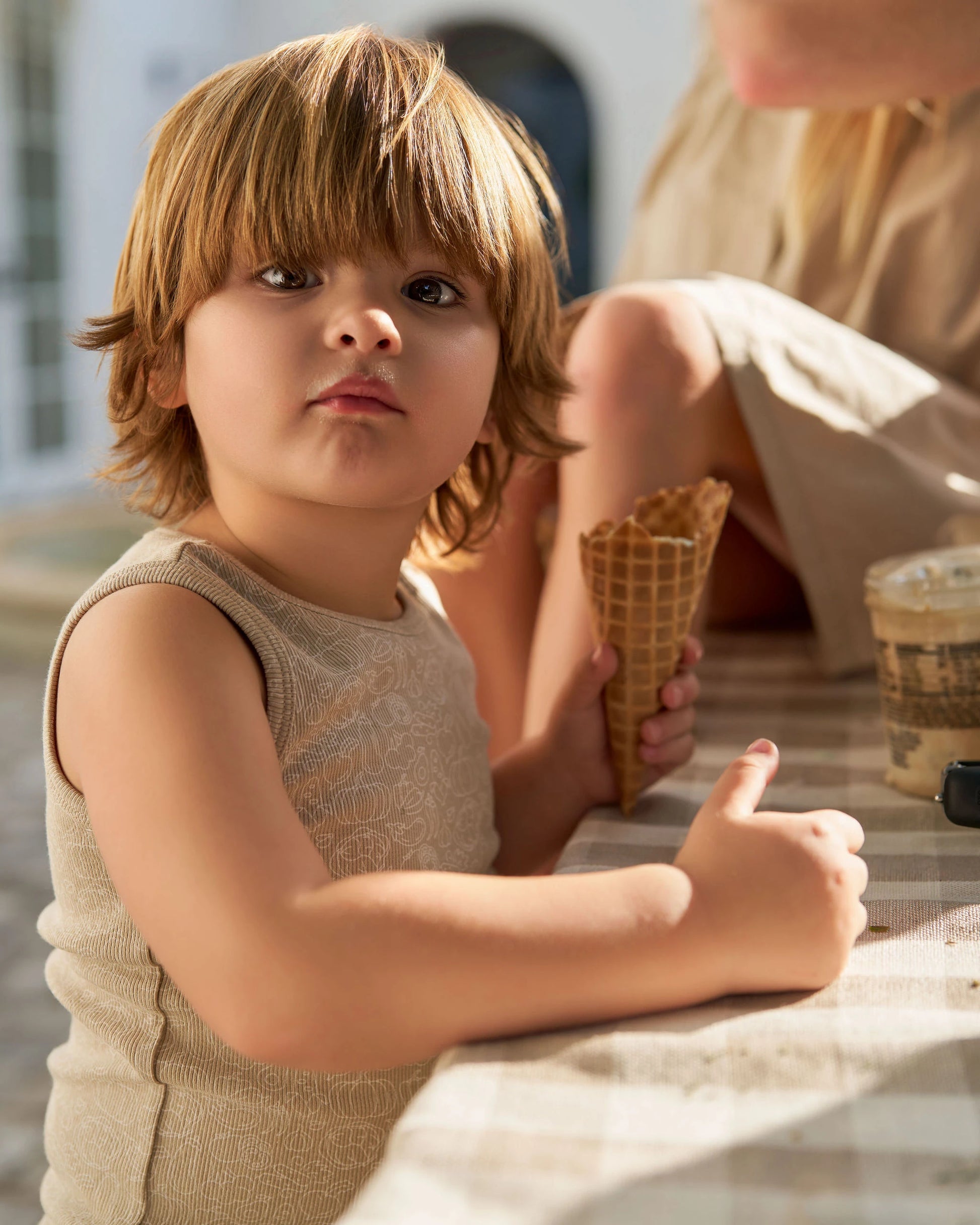 Child wearing beige Family Ribbed Print Sets for Summer and Spring holding ice cream cone at table