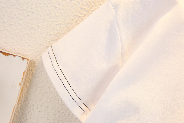 Close-up of white sleeve with black stitching detail in Fashion Baby Boys T Shirt and Denim Shorts Summer Set Casual Kids Outfit