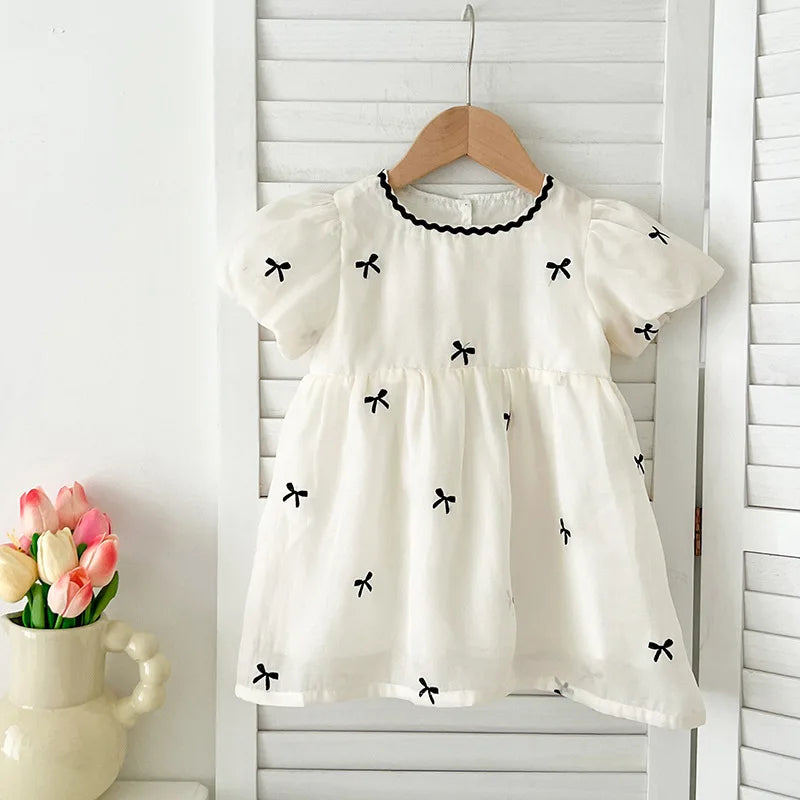 Fashion Baby Girls Embroidered Bow Puff Sleeve Cotton Backless Princess Dress in white with black bow details