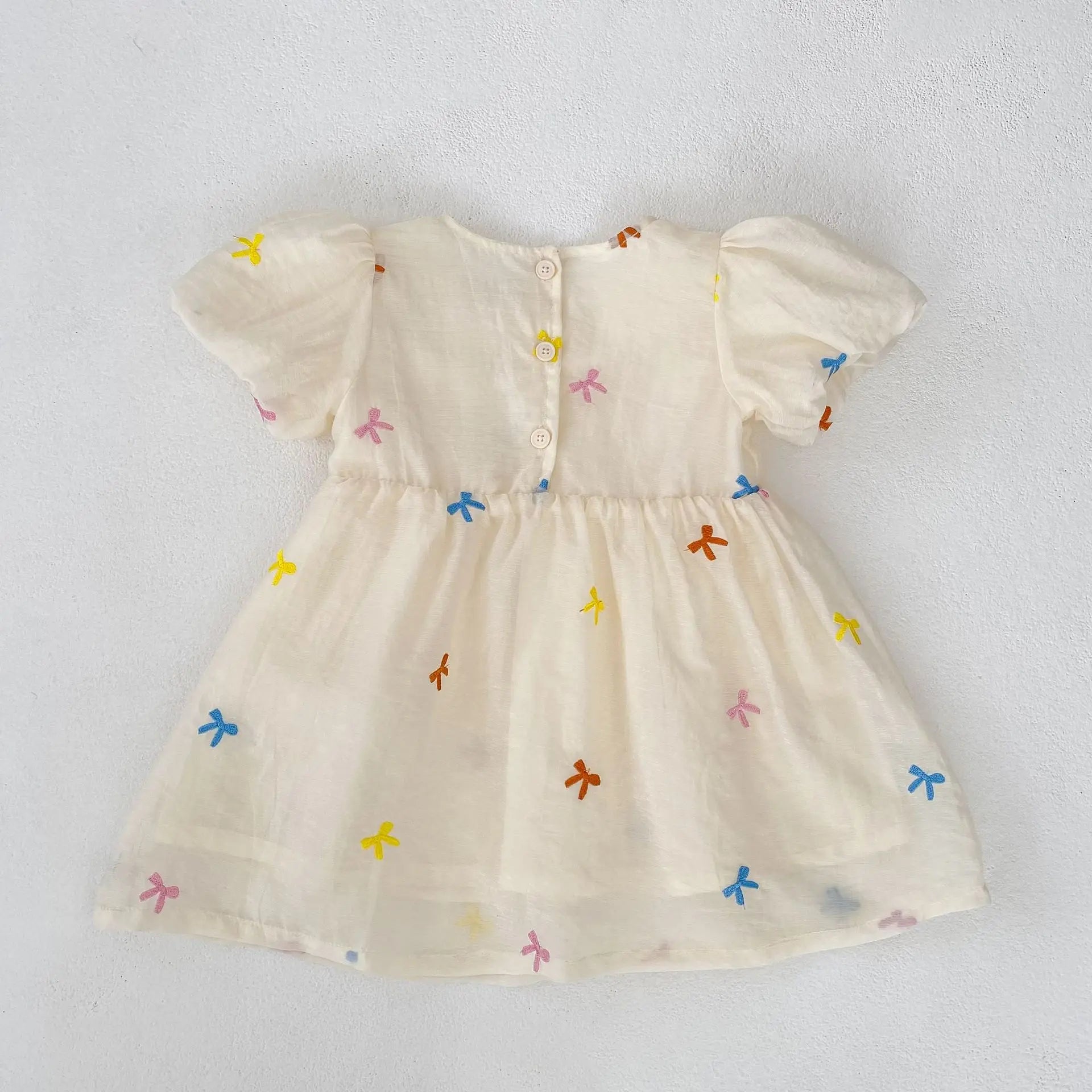 Fashion Baby Girls Embroidered Bow Puff Sleeve Cotton Backless Princess Dress in off-white with colorful bow patterns