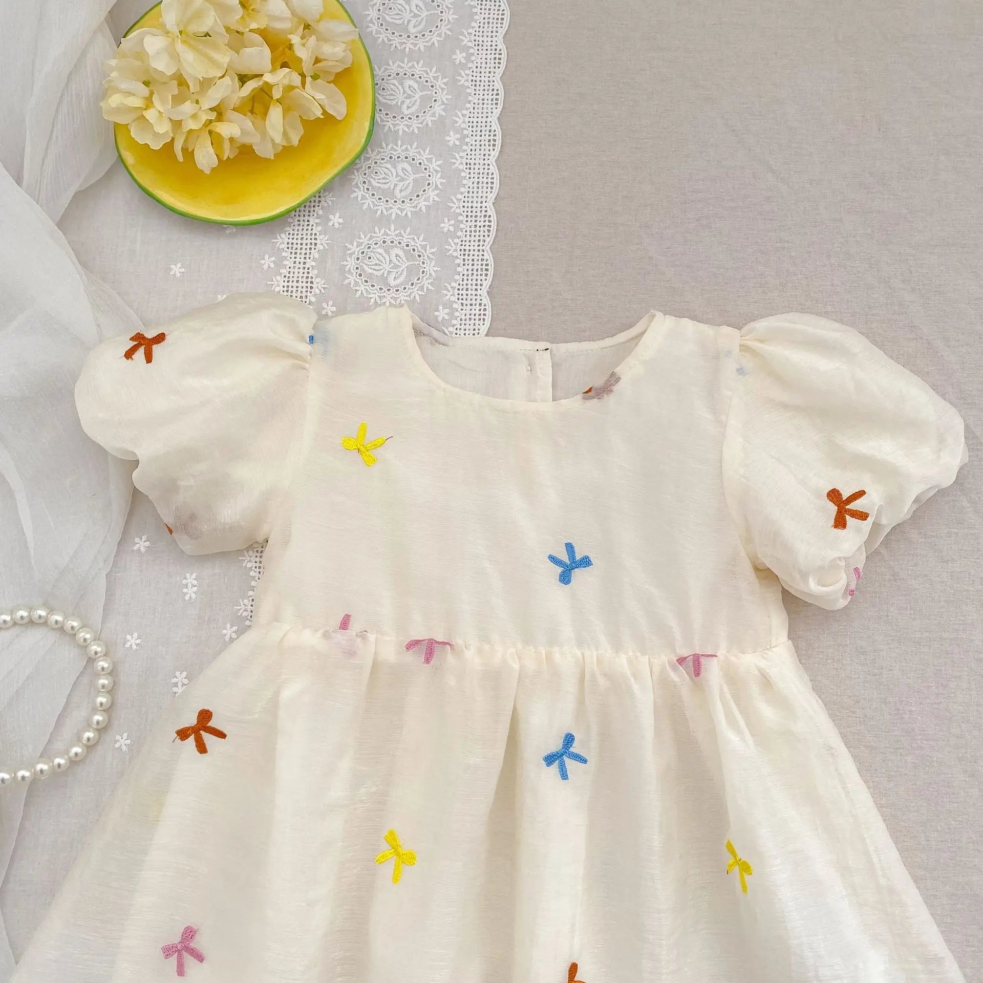 Fashion Baby Girls Embroidered Bow Puff Sleeve Cotton Backless Princess Dress in white with colorful bow embroidery 