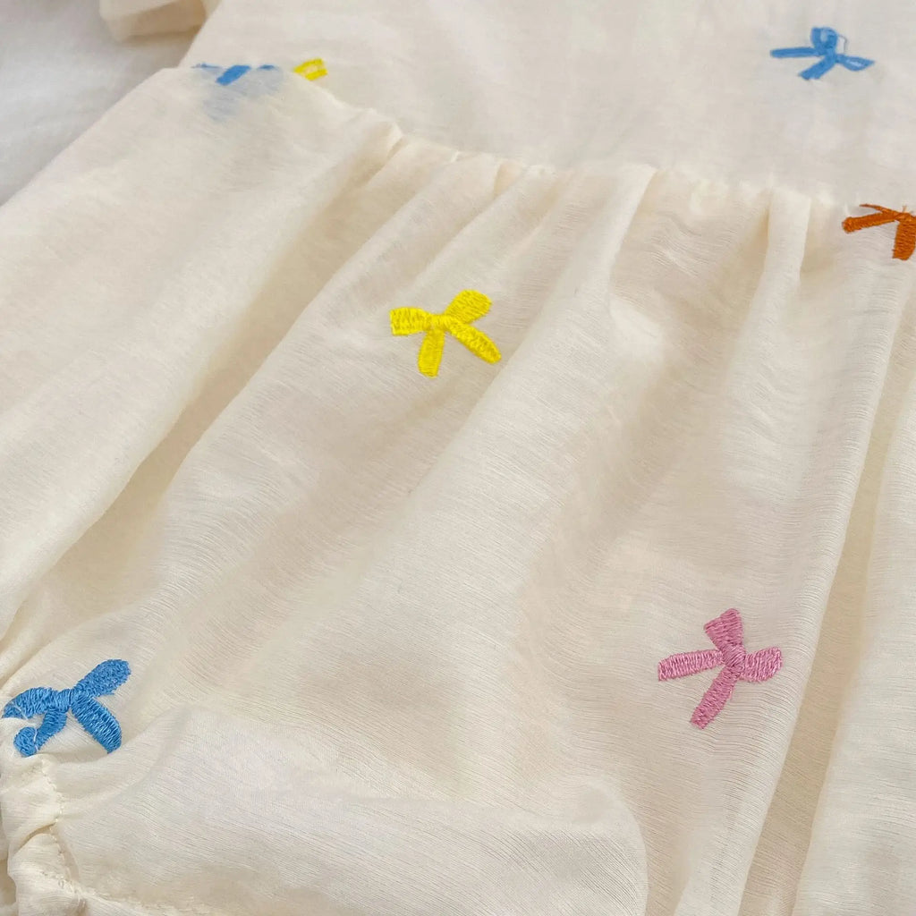 Close-up of Fashion Baby Girls Embroidered Bow Puff Sleeve Cotton Backless Princess Dress with colorful bow designs