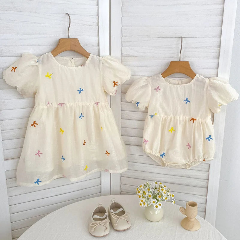 Fashion Baby Girls Embroidered Bow Puff Sleeve Cotton Backless Princess Dress in cream with colorful bow embroidery on two styles