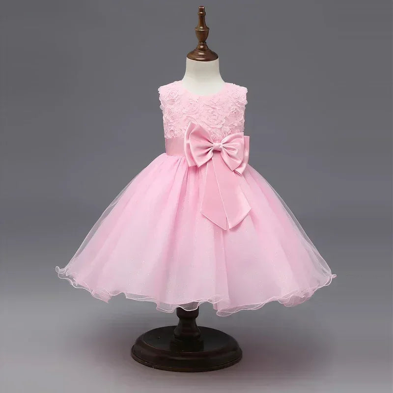Pink sleeveless girl's party dress with lace bodice and large bow on waist for special occasions