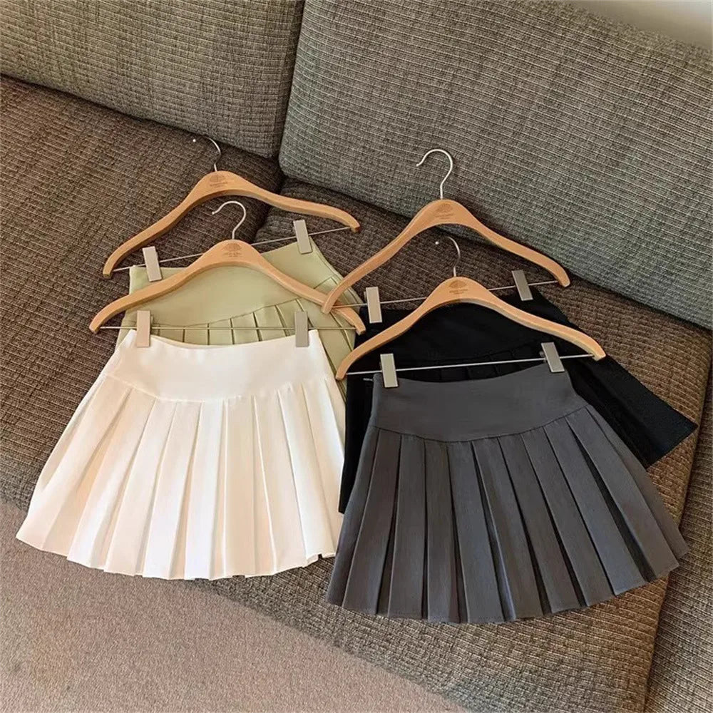 Fashion Girls Clothing Summer Casual Little Girls Solid Color High Waist Skirt displayed in white gray and olive colors on wooden hangers