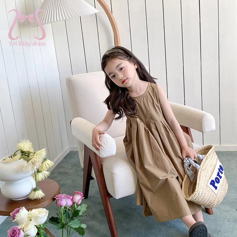 Fashion Girls Cotton Large Skirt Fairy Dress Summer Kids Sleeveless Korean Style worn by girl sitting on white chair holding straw bag